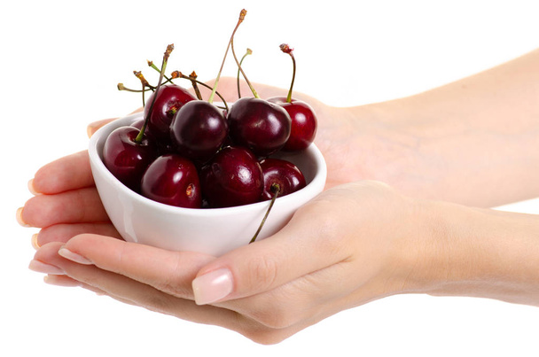 Cherries in a bowl in hands - Φωτογραφία, εικόνα