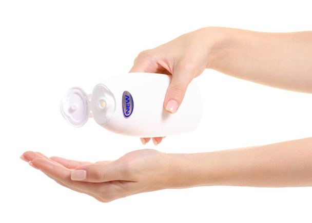 White bottle of shower gel lotion cream in hands new - Foto, imagen