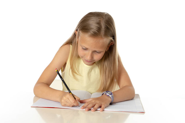Education at home concept.  cute young little blonde caucasian girl studying or doing  home work at  table with pile of books, educational studying concept on white background - Foto, Imagem