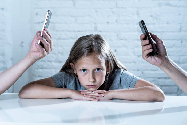 mother and father using mobile phones neglecting little sad ignored daughter bored and lonely feeling abandoned and disappointed with  parents.  mobile cell smart phone addiction bad behavior concept - Fotoğraf, Görsel