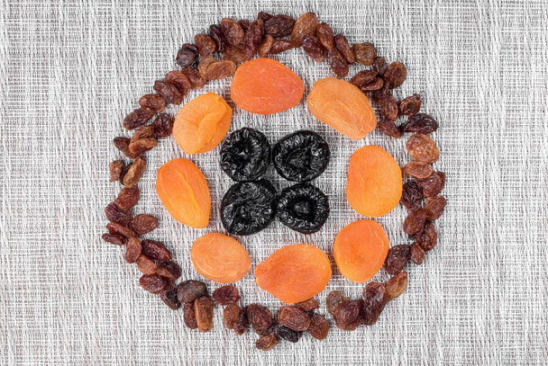 Dried plums, kuraga and raisins on a woven cloth - Photo, Image