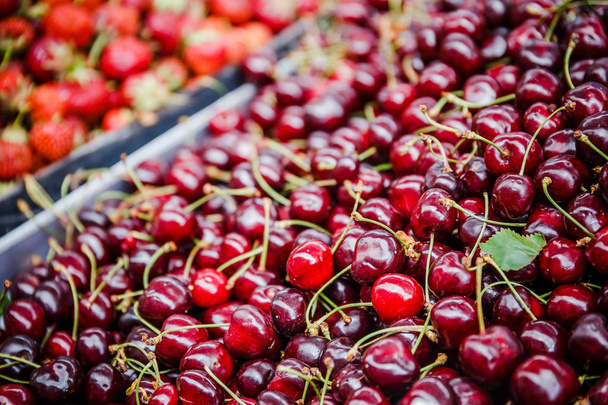 Fresh cherries in box at a farmers market - Фото, зображення