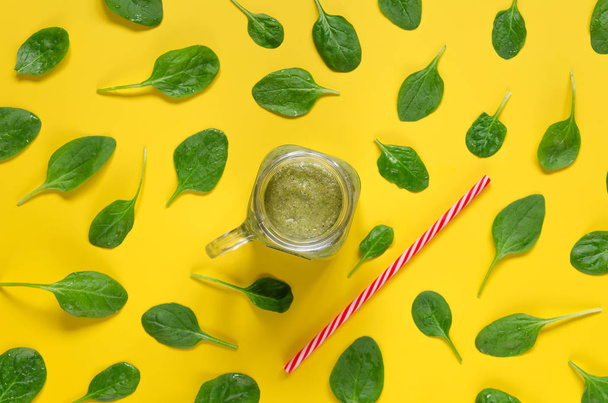 Freshly prepared green smoothie on yellow background. Clean Eating. Overhead food shots - Φωτογραφία, εικόνα