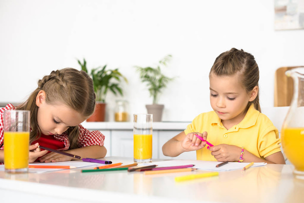 portrait of cute little kids drawing pictures at table at home - Foto, Bild
