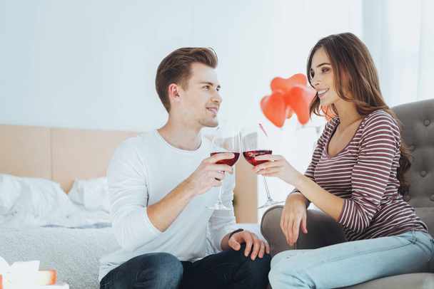 Joyful young couple having wine - Photo, Image