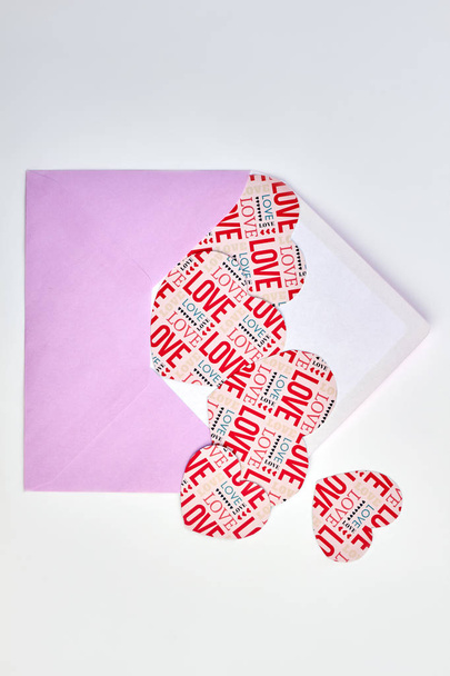 Colorful envelope with paper hearts. - Valokuva, kuva
