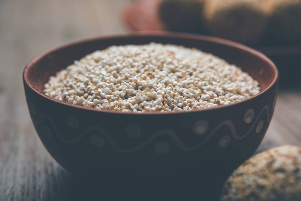 Amaranth or rajgira lahi in a bowl with sweet laddu. selective focus - Photo, Image