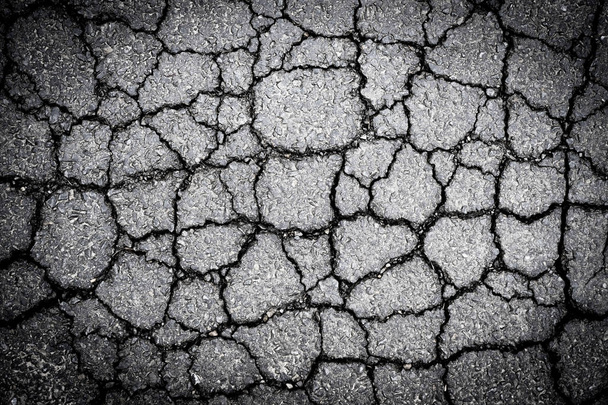 Old worn and cracked asphalt with cracks - Φωτογραφία, εικόνα