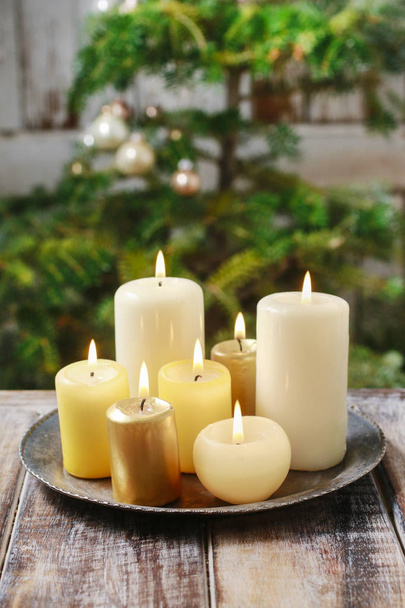 Candles on wooden table. Christmas decorations. - Foto, afbeelding