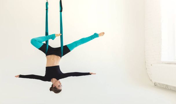 Donna che pratica fly yoga su sfondo bianco
 - Foto, immagini