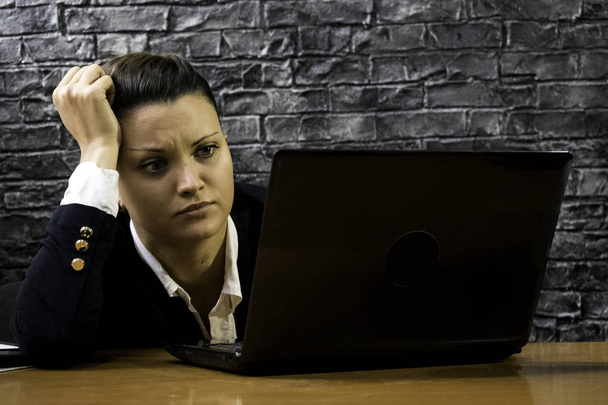 frustrated young business woman in front of a laptop - Photo, Image