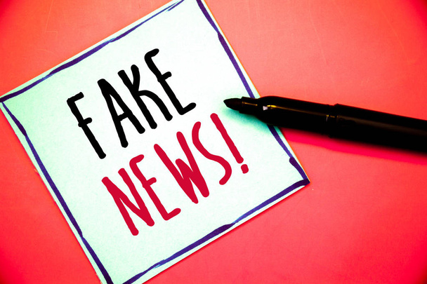 Conceptual hand writing showing Fake News Motivational Call. Business photo texts False Unsubstantiated Information HoaxIdeas messages white paper black red letters pen resting on red background - Photo, Image