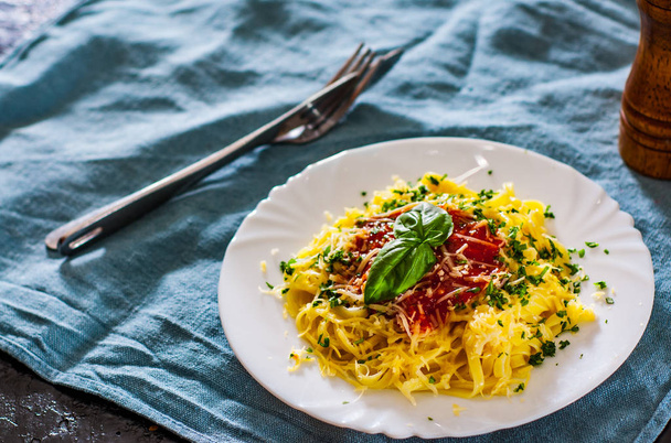 Linguine pasta with fresh tomato sauce, grated cheese and basil in white plate - Фото, зображення