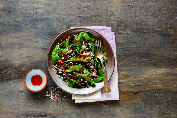 Homemade lettuce, beans, feta cheese and honey dressing organic energy boosting salad on wood background. Diet, dieting concept. Vegetarian food, healthy eating. Flat lay style - 写真・画像