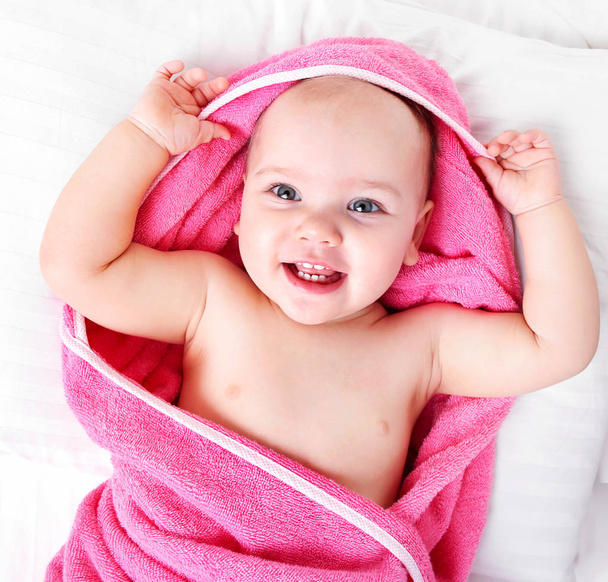 Baby girl smiling portrait in towel. - Foto, Imagen