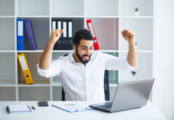 Excited young businessman celebrate victory cheerful in modern office - Photo, image