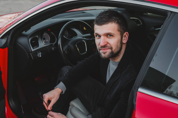 young handsome man posing in car  - Fotografie, Obrázek