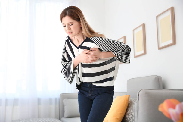 Woman having heart attack at home - Фото, изображение