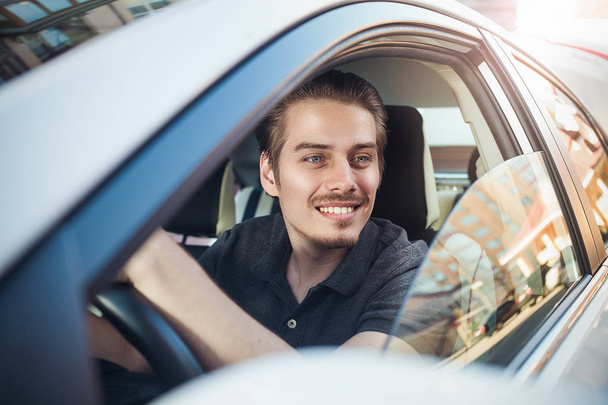 Enjoy the drive. Image of young handsome guy sitting in car. - 写真・画像
