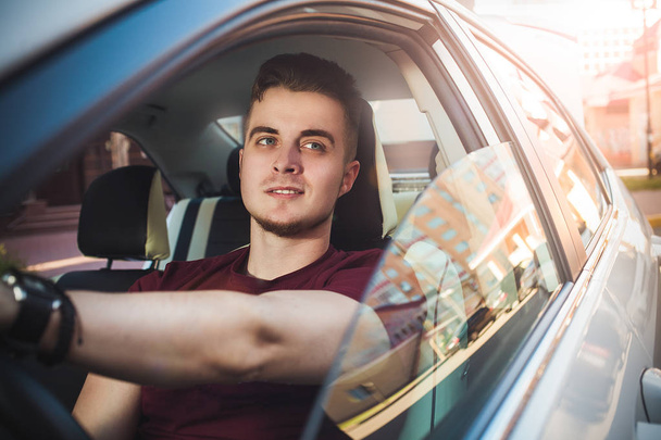 Enjoy the drive. Image of young handsome guy sitting in car. - Foto, imagen