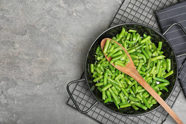 Flat lay composition with frozen green beans on grey background. Vegetable preservation - Fotó, kép