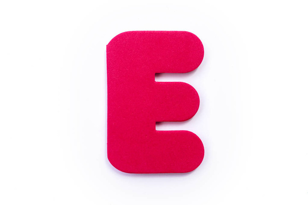 Red letter E over a white background. - Fotoğraf, Görsel