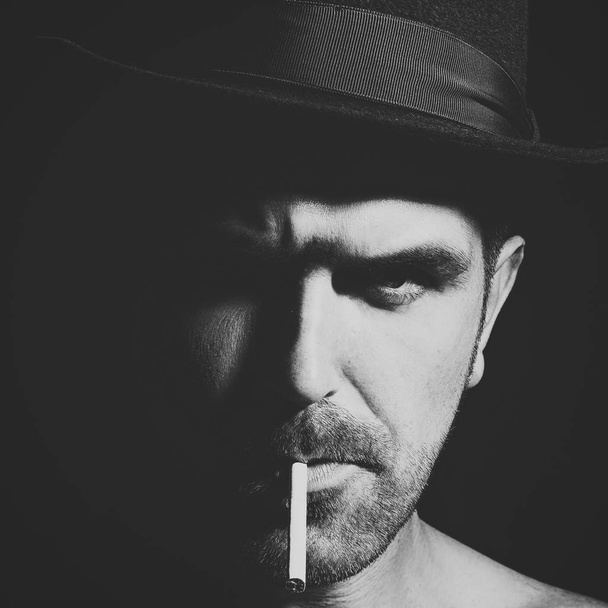brutal male portrait. Man with cigarette - Foto, Imagen