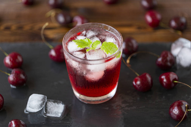 Fresh cold cherry cocktail with mint and ice. - Fotoğraf, Görsel