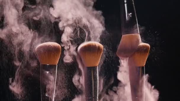 Cosmetics brushes and explosion colorful makeup powder - Footage, Video