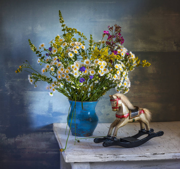 still life with flowers and a wooden toy. vintage. - Photo, Image