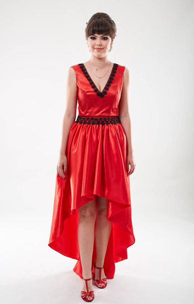 Full length studio portrait of a beautiful young woman in red dress - Fotografie, Obrázek
