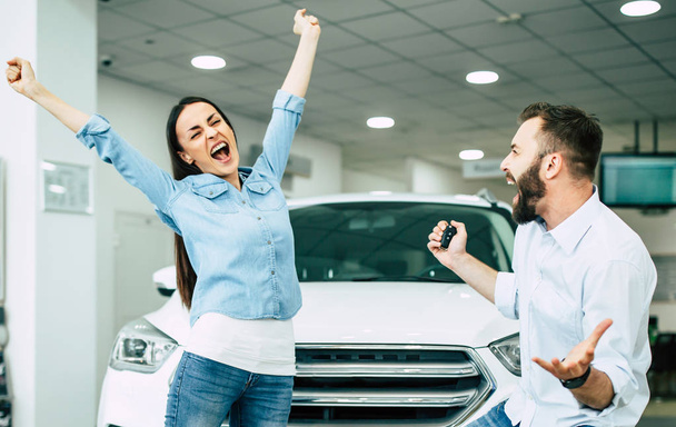 happy young couple exciting of buying new car in delarship - Foto, Imagem