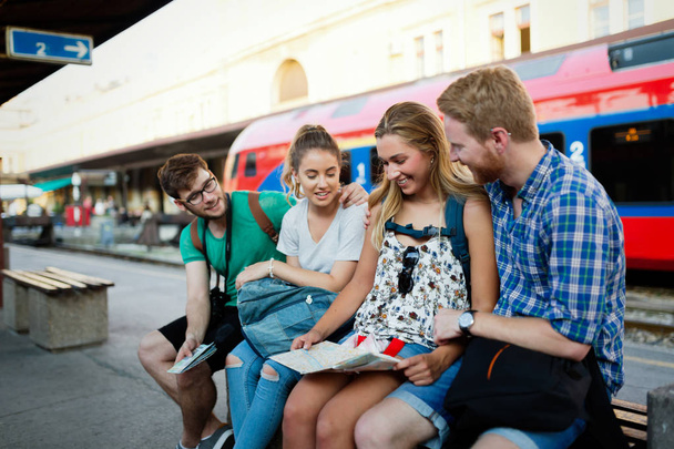 Group of happy tourists traveling by train - Фото, зображення