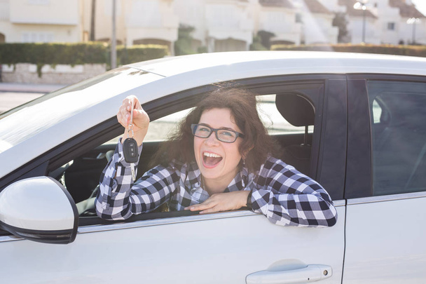 Молода щаслива жінка показує ключ нового автомобіля
 - Фото, зображення