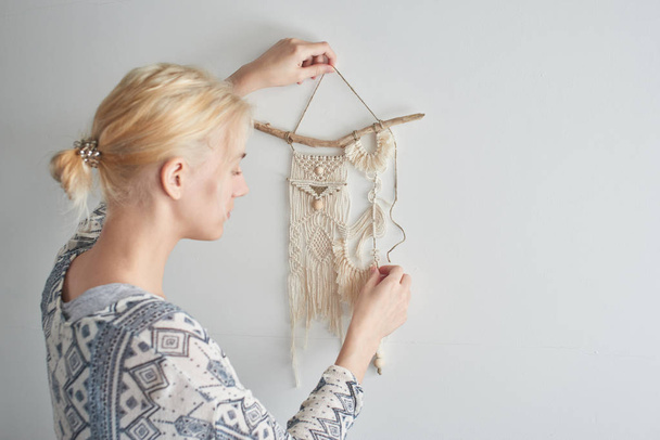 woman making canvas of threads, macrame decoration concept  - Фото, изображение