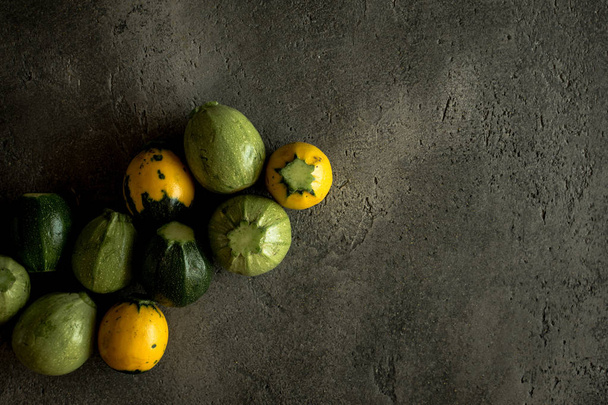 Yellow and Green Round Zucchini on Rustic Dark Background - Fotografie, Obrázek