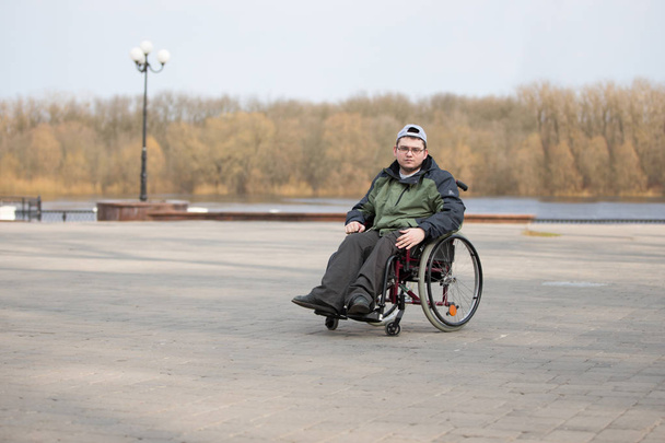 A man in the street in a wheelchair - Photo, Image