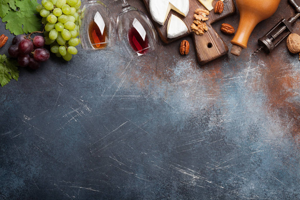 Wine, grape, nuts and cheese on stone background. Top view with space for your text - Photo, image