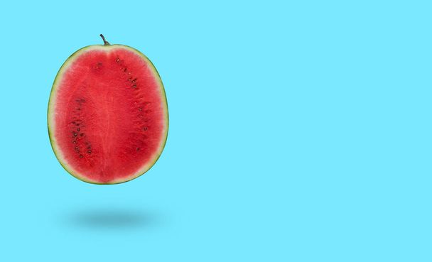 Cutted watermelon isolated on blue background with a shadow and copy space - Φωτογραφία, εικόνα