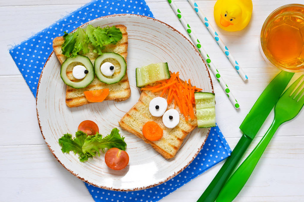 Breakfast for a child - children's funny toasts with a grilled and carrot. - Фото, зображення