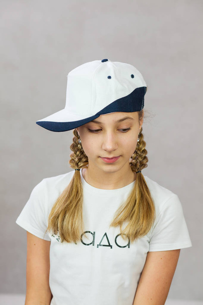 cute girl with pigtails in a cap - Fotografie, Obrázek