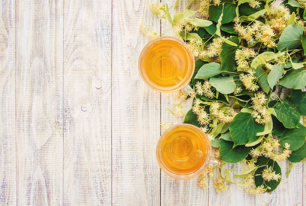 linden tea and flowers. Selective focus.  - Fotó, kép