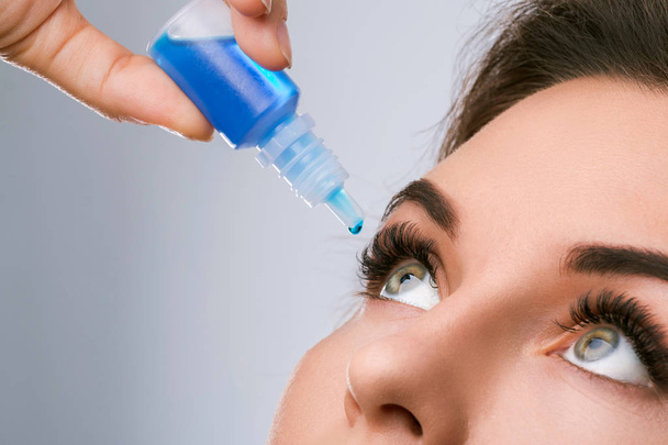 Close up view of woman using eye drops - Foto, Bild