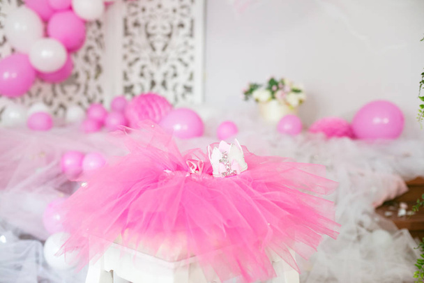 First birthday. Pink skirt-tutu, crown, and balloons and flowers decorated party - Fotó, kép