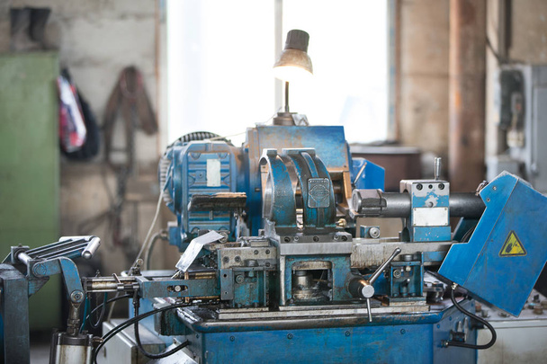 Belarus, Gomel, 25 April 2018. Factory for the manufacture of ventilation pipes.The old machine in the Russian factory for metal cutting - Foto, imagen