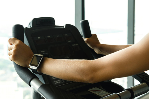 Close up view of female hand with smart watch in the gym - Foto, afbeelding