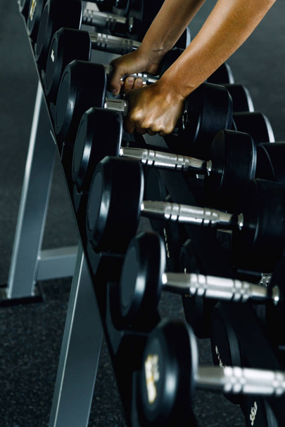 Row of dumbbells and female hands - Photo, image