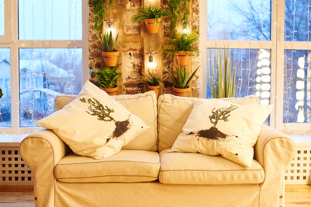 white sofa with stylish pillows near windows in apartment  - Zdjęcie, obraz