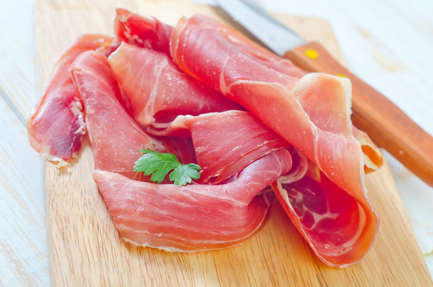 Proscuitto on a wooden board - Photo, image