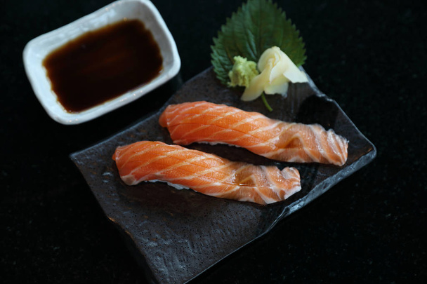 Salmon sushi on black plate japanese food  - Photo, Image